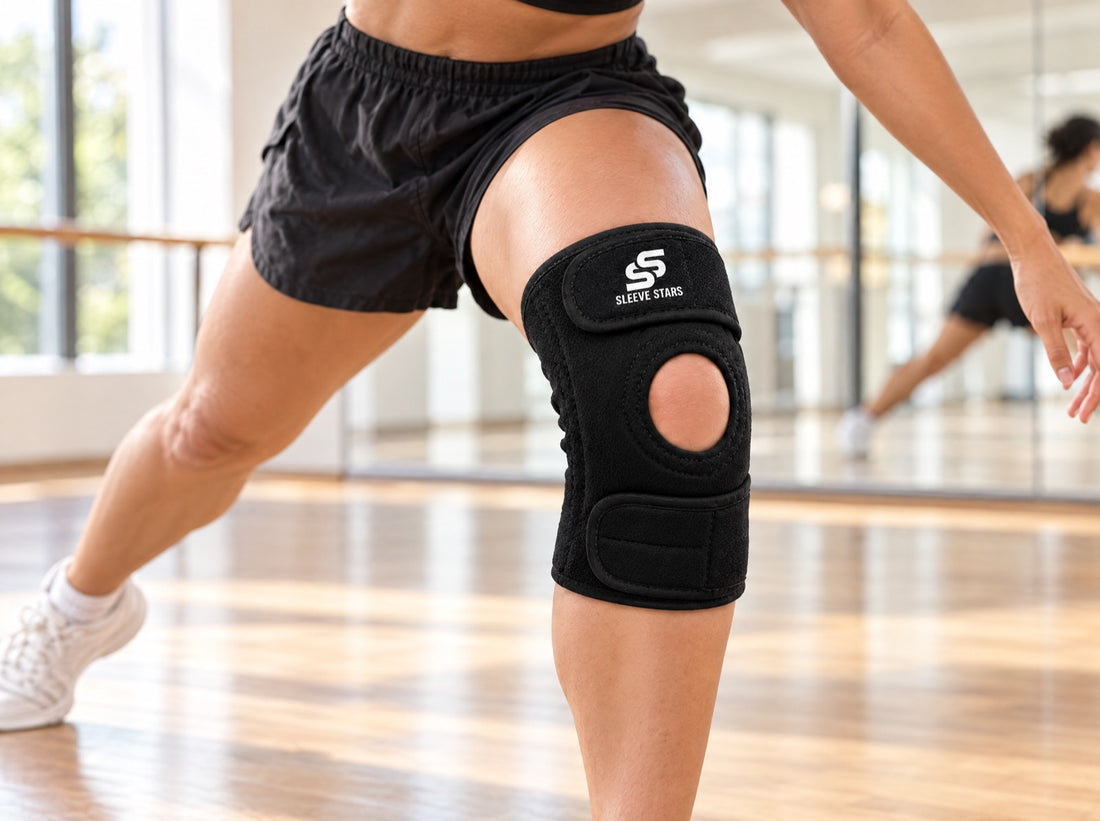 A contemporary dancer in shorts mid-movement in a bright dance studio with mirrors, wearing the Sleeve Stars Knee Brace
