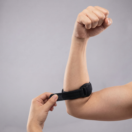 Person tightening the elbow brace strap